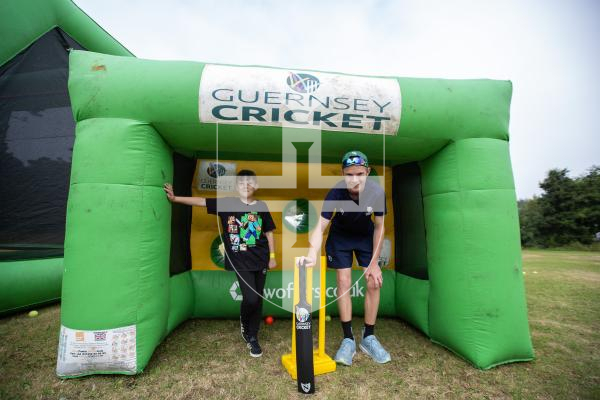 Picture by Karl Dorfner. 31-08-2024 - The Sauzmarez Park Sports Day Event - Mikey Le Page (9) with organiser Harry Bisson at the Guernsey Cricket section