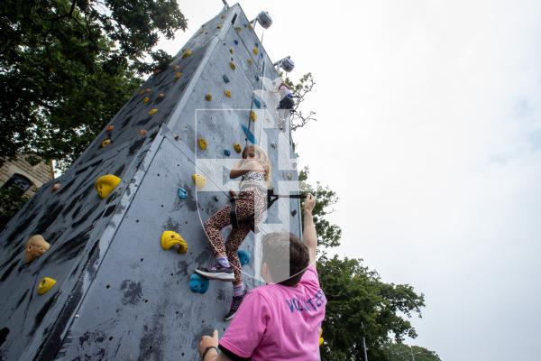 Picture by Karl Dorfner. 01-09-2024 - Havelet Regatta - Louisa Batiste (6) on the climbing wall being helped by volunteer Tom Lees