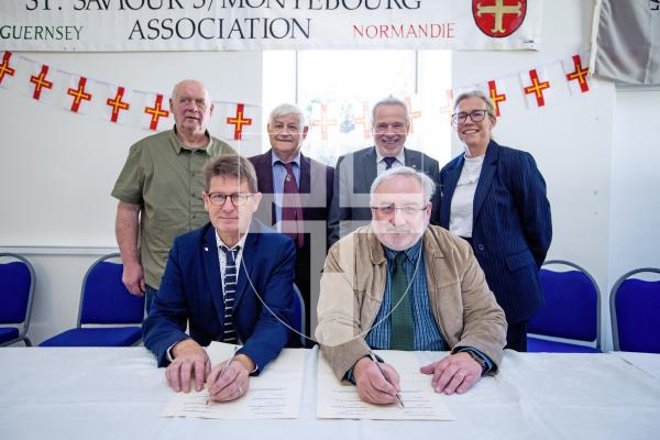 Picture by Peter Frankland. 13-09-24 St Saviours Community Centre. A ceremony was held to celebrate the 30th anniversary of the twinning of the parish with Montebourg. All the people who signed the document - L-R - (Front) Jean-Paul Manquest (mayor of Montebourg) and Paul Connolly (senior constable St Saviours). Back L-R - Maurice Varin, (President of the twinning committee, Montebourg). Jim De Garis, Stuart Crisp (President of the twinning committee, Guernsey) and Deputy Bailiff Jessica Roland.