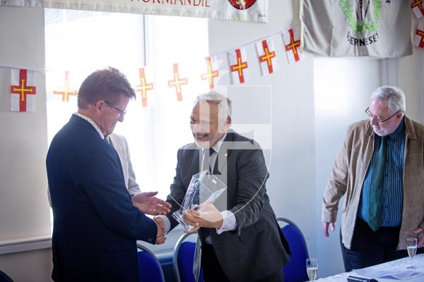 Picture by Peter Frankland. 13-09-24 St Saviours Community Centre. A ceremony was held to celebrate the 30th anniversary of the twinning of the parish with Montebourg. Stuart Crisp presents the Mayor of Montebourg Jean-Paul Manquest with a gift.