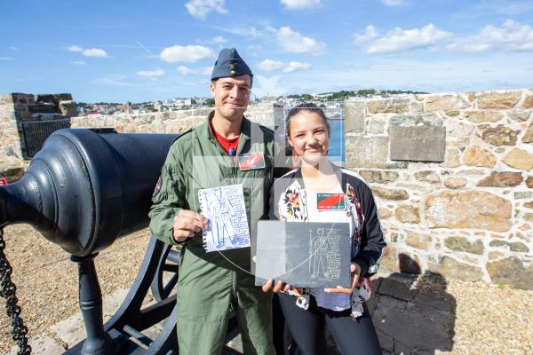 Picture by Karl Dorfner. 14-09-2024 - 'Guernsey's Own 201' squadron firing the noon day gun - Alexander Connor, wing commander, and 13 year old Jane Van der Watt with the drawing she made of Alexander, which was then converted to a slate version, also with her return gift of squadron name badge on her top