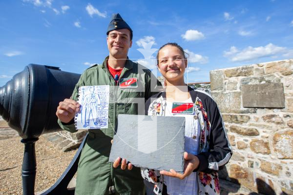 Picture by Karl Dorfner. 14-09-2024 - 'Guernsey's Own 201' squadron firing the noon day gun - Alexander Connor, wing commander, and 13 year old Jane Van der Watt with the drawing she made of Alexander, which was then converted to a slate version, also with her return gift of squadron name badge on her top