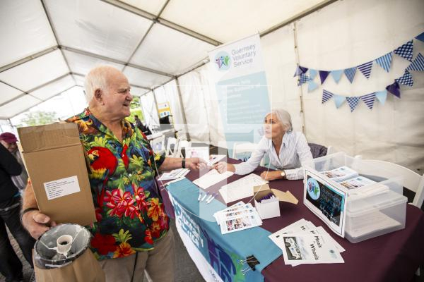 Picture by Sophie Rabey.  16-09-24.  Housing 21 along with Rosaire Community Association, Health Connections and other local charities, organisations and States Departments held Guernseys first 'Celebrating Age Festival'.  It is targeted at over 55s and hopes to become an annual event.  There were a lot of stalls available for people to go and see and get information from.
Barry Sansom (82) talking with Denise Cohu from Guernsey Voluntary Service.