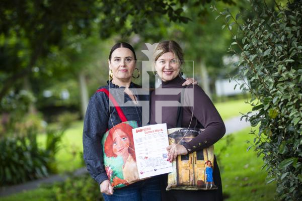 Picture by Sophie Rabey.  16-09-24.  Jelena Kovolevska (right) has organised a Georgian culture week for the beginning of October, with the aim of introducing a bit of Georgian culture to locals in Guernsey.  There will be jewelry workshops at Les Cotils, art exhibitions and a concert with Georgian cuisine.
L-R Olga Mitchell and Jelena Kovolevska holding bags by a Georgian artist, Kakha Khinveli, who will be over for the week.