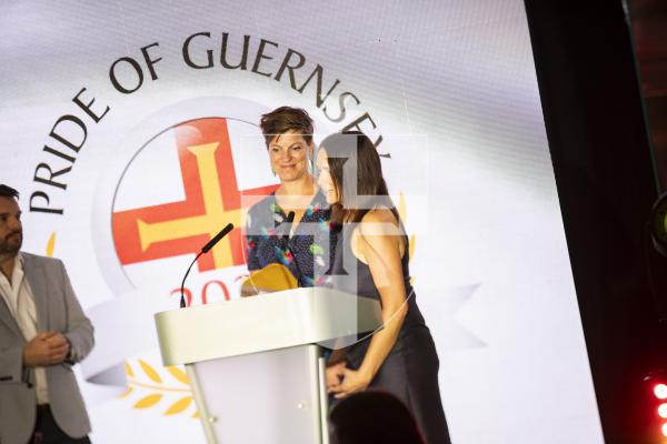 Picture by Sophie Rabey.  07-10-23.  Pride of Guernsey 2023 Awards at St Pierre Park.
Angel of the Year, sponsored by Ravenscroft.  WINNER - Reparative Care Team.
Jo Ogier (service manager for family health, navy dress), Rosy Corbin (therapeutic practitioner, flowery dress) presented by Robin Newbould (Ravenscroft)