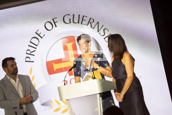 Picture by Sophie Rabey.  07-10-23.  Pride of Guernsey 2023 Awards at St Pierre Park.
Angel of the Year, sponsored by Ravenscroft.  WINNER - Reparative Care Team.
Jo Ogier (service manager for family health, navy dress), Rosy Corbin (therapeutic practitioner, flowery dress) presented by Robin Newbould (Ravenscroft)