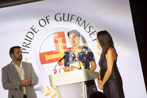 Picture by Sophie Rabey.  07-10-23.  Pride of Guernsey 2023 Awards at St Pierre Park.
Angel of the Year, sponsored by Ravenscroft.  WINNER - Reparative Care Team.
Jo Ogier (service manager for family health, navy dress), Rosy Corbin (therapeutic practitioner, flowery dress) presented by Robin Newbould (Ravenscroft)