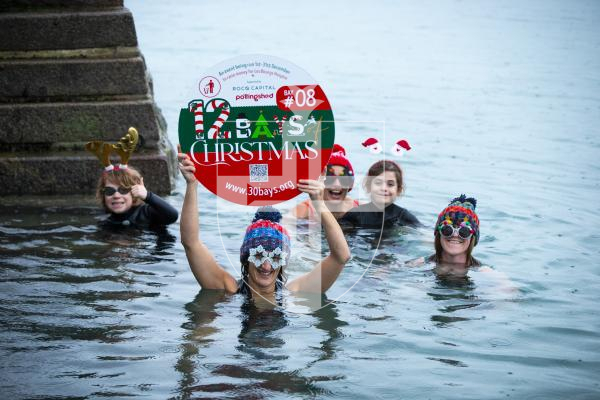 Picture by Luke Le Prevost. 29-11-23.
Preview for Les Bourgs Hospice 12 Bays of Christmas fundraiser launching on the 1st December, pictured at Rousse Pier. L-R  Jack Sealey (10), Liz Stonebridge (fundraising administrator), Kerry Marley, Jude Marley (9) and Dawn Sealey