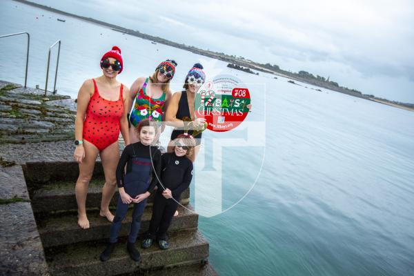 Picture by Luke Le Prevost. 29-11-23.
Preview for Les Bourgs Hospice 12 Bays of Christmas fundraiser launching on the 1st December, pictured at Rousse Pier. L-R Back row: Kerry Marley, Dawn Sealey and Liz Stonebridge (fundraising administrator). Front row: Jude Marley (9) and Jack Sealey (10)