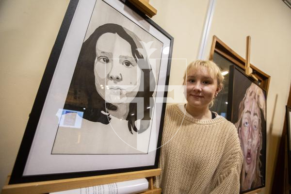 Picture by Luke Le Prevost. 29-11-23.
Sovereign Art Foundation Students Prize exhibition, auction and awards at St James. Eva Drew (18) with 'Self-Portrait in Grey'