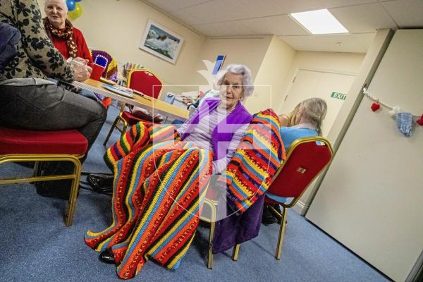 (Picture taken by Kai Correia - 09-03-24) Joan le Page with 3 of her knitted blankets that she made for the foundation.