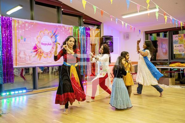 Picture by Sophie Rabey.  16-03-24.  Holi - Festival of Colours - celebration at Cobo Community Centre.  A series of perfomances were played out to explain the story of the famous Hindu festival.
Ladies L-R Sukritha Rao, Poonam Solanki and Anne Jacob dancing around Sanvi Singh (6) and Thaarini Rao (7).