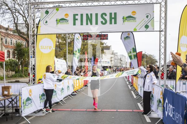 Picture by Sophie Rabey.  14-04-24.  Sure Guernsey Marathon 2024.
First Lady over the finish line, Lindsay Sword.