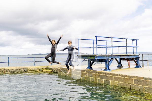 Picture by Sophie Rabey.  22-07-25.  Juno Havard (11) and Ivo Havard (10) enjoying the diving board at The Bathing Pools.