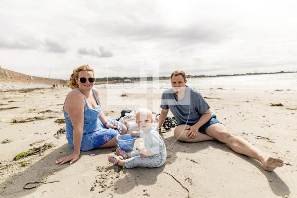 Picture by Sophie Rabey.  23-07-25.  Vazon Bay and Petit Bot have been nominated as two of the Channel Islands top beaches in a recent Country File article.  Vox pop on the beaches.
Belinda McCarthy and Nathan Portepus with baby Henry Portepus (15 months) after his first ever sea swim.