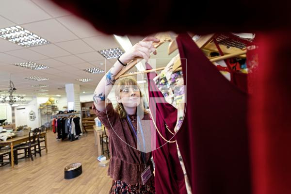 Picture by Peter Frankland. 26-08-25Health Connections are moving out of the former Edinburgh Woollen Mill building to make room for an Iceland shop to move in. Erris Heneghan clearing out some of the clothes.