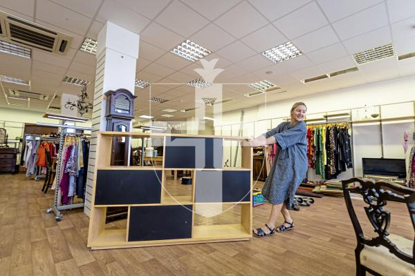 Picture by Peter Frankland. 26-08-25Health Connections are moving out of the former Edinburgh Woollen Mill building to make room for an Iceland shop to move in. Agi Savcenko moving some of the furniture stock.