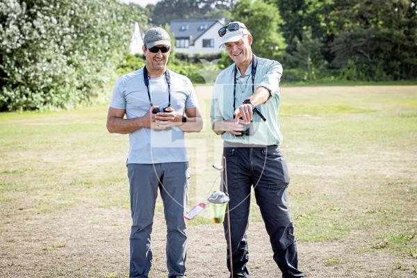 Picture by Sophie Rabey.  26-08-25.  The Asian Hornet team undertaking a 'tinsel tracking' technique (that involves attaching a long visible strip on a worker hornet to track it back to its nest) at La Mare De Carteret Playing Fields.  
L-R Nik Carre (Land Management & Asian Hornet Officer for Agriculture, Countryside & Land Management Services) and Francis Russell (Project Coordinator - Asian Hornet Strategy).