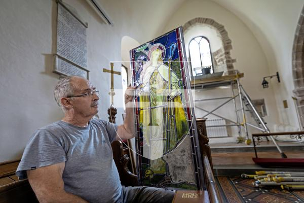 Picture by Peter Frankland. 27-08-25 A stained glass window at Forest Church has been removed, restored and is now being reinstalled in place. Peter Vivian of Guernsey Glass Craft was carrying out the work.