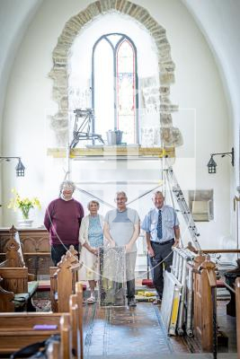 Picture by Peter Frankland. 27-08-25 A stained glass window at Forest Church has been removed, restored and is now being reinstalled in place. L-R - Rev Adrian Datta, Nancy Smith (member of the church), Peter Vivian (Guernsey Glass Craft) and Keith Bienvenu, (People's Churchwarden).