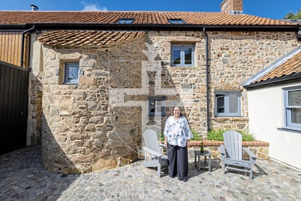 Picture by Sophie Rabey.  02-09-25.  Ken and Wendi Overby are over visiting Guernsey from the US and trying to trace back Wendi's family history.  Her family used to live at Les Galliennes in Talbot Valley, the lovely farmhouse belonging to Darren Etasse and his family.  They had a tour around the premises today.
