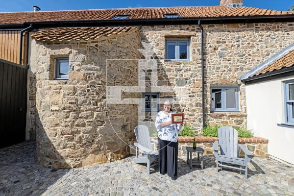 Picture by Sophie Rabey.  02-09-25.  Ken and Wendi Overby are over visiting Guernsey from the US and trying to trace back Wendi's family history.  Her family used to live at Les Galliennes in Talbot Valley, the lovely farmhouse belonging to Darren Etasse and his family.  They had a tour around the premises today.