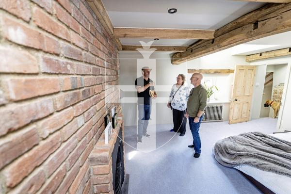 Picture by Sophie Rabey.  02-09-25.  Ken and Wendi Overby are over visiting Guernsey from the US and trying to trace back Wendi's family history.  Her family used to live at Les Galliennes in Talbot Valley, the lovely farmhouse belonging to Darren Etasse and his family.  They had a tour around the premises today.