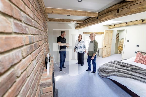 Picture by Sophie Rabey.  02-09-25.  Ken and Wendi Overby are over visiting Guernsey from the US and trying to trace back Wendi's family history.  Her family used to live at Les Galliennes in Talbot Valley, the lovely farmhouse belonging to Darren Etasse and his family.  They had a tour around the premises today.