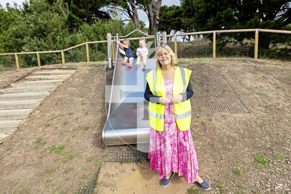 Picture by Sophie Rabey.  09-09-25.   St Sampson's douzenier Kim Abbotts at Delancey Park to give update on what the response has been of the new fencing around the childrens play area.
Kim with children on the slide L-R Edie-Rae Demouilpied (2) and Piper Crowson (3)