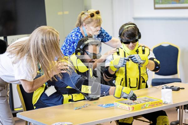 Picture by Sophie Rabey.  09-09-25.  A demonstration of the new Dementia Suits at Guernsey Alzheimer's Assocation.  
Guernsey Alzheimer's are introducing the suits conjunction with the Admiral Nurses to raise awareness of the physical challenges that people with dementia and old age might face in day to day tasks.  Luke Keohane from ITV and Ollie Guillou who hosts a Dementia Podcast undertake a series of different tasks for an experiment on ease.