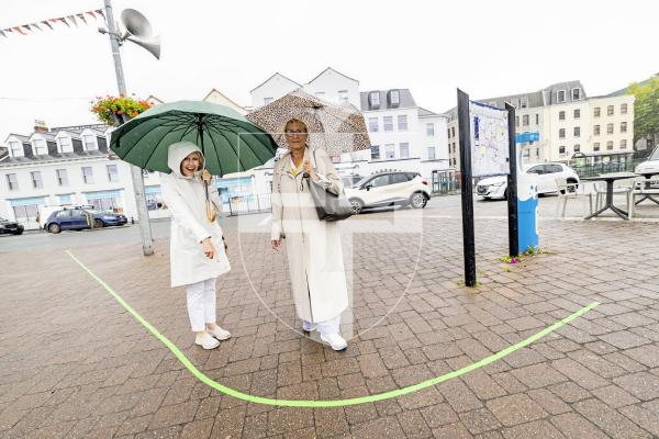Picture by Sophie Rabey.  10-09-25.  Guernsey Arts have installed a Green Line across St Peter Port pavements as a self-guided walk through Guernsey's historic town.
L-R Ann Kilkenny from Australia and Lisa Lee, originally from Guernsey but now lives in France, standing by the new Green Line.