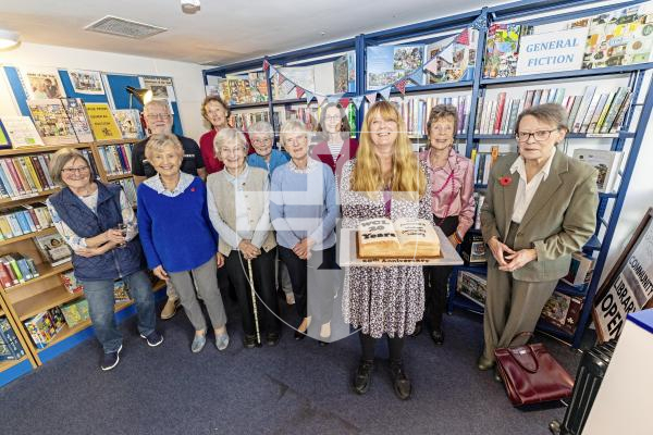 Picture by Sophie Rabey.  10-11-25.  The Western Community Library is celebrating 20 years with a party at St Saviour's Community Centre.
Users and volunteers of the Library at the community centre.
Jackie Burgess, Guille-Allès Library's Community and Wellbeing Lead, holds a celebration cake.