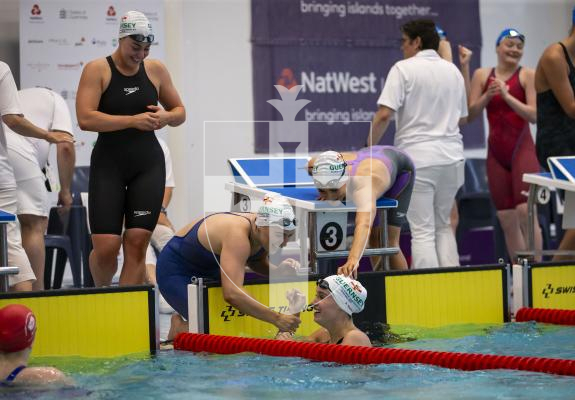 Picture By Peter Frankland. 13-07-23 Guernsey NatWest International Island Games 2023. Swimming Day Four. Celebration at the end of the 4x100 medley relay. Ailish Rabey in the water with Orla Rabey, Tatiana Tostevin and Laura Le Cras behind.