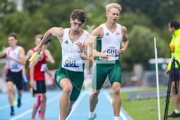 Picture By Peter Frankland. 14-07-23 Guernsey International Island Games 2023. Footes Lane - Athletics. Peter Curtis takes over from Josh Duke in the 4x400m relay.