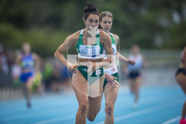 Picture By Peter Frankland. 14-07-23 Guernsey International Island Games 2023. Footes Lane - Athletics. Hannah Lesbirel takes over from Rebecca Toll in the 4x400m relay.