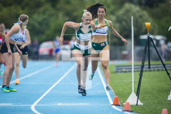Picture By Peter Frankland. 14-07-23 Guernsey International Island Games 2023. Footes Lane - Athletics. Sophie Porter takes over from Hannah Lesbirel in the 4x400m relay