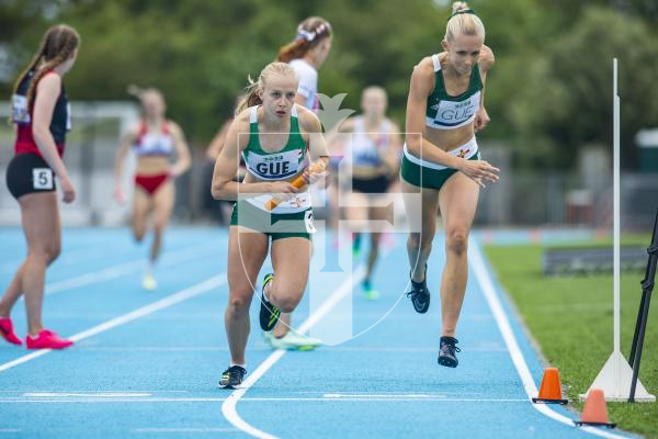 Picture By Peter Frankland. 14-07-23 Guernsey International Island Games 2023. Footes Lane - Athletics. Abi Galpin takes over from Sophie Porter in the 4x400m relay.
