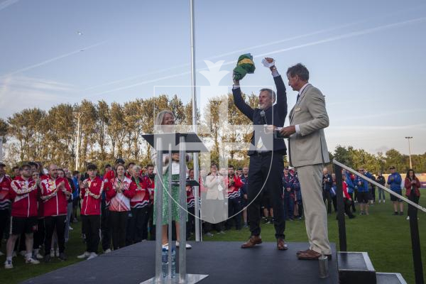 Picture By Peter Frankland. 14-07-23 Guernsey International Island Games 2023. Closing Ceremony at Footes Lane. The flag is handed over from Dame Mary Perkins to Gordon Deans chair of Orkney IG organising committee with Jorgen Pettersson (right).