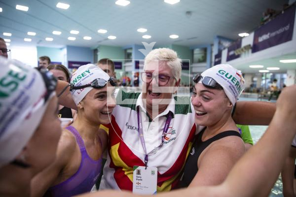 Picture By Peter Frankland. 13-07-23 Guernsey NatWest International Island Games 2023. Swimming Day Four. Laura Le Cras, coach Sara Parfit and Tatiana Tostevin. Celebration at the end of the 4x100m medley relay.