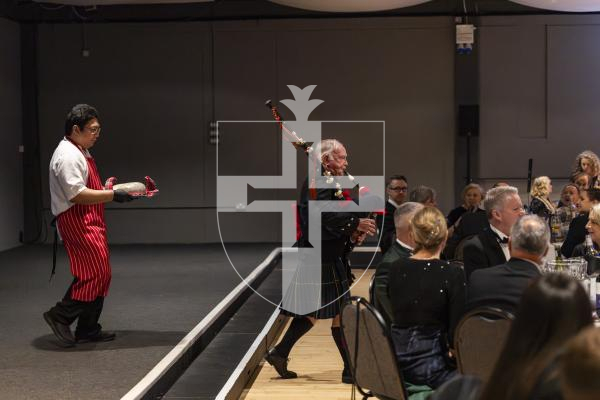 Picture by Sophie Rabey.  31-01-26.  Guernsey's Scottish Association held the Burns Night celebrations at Beau Sejour, sponsored by Titan Wealth.  The Haggis was piped in by Chris Bradshaw (piper) and carried by Mikee Bataller (chef).