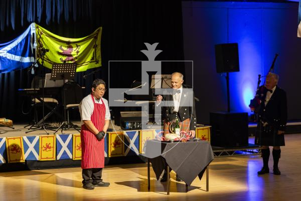 Picture by Sophie Rabey.  31-01-26.  Guernsey's Scottish Association held the Burns Night celebrations at Beau Sejour, sponsored by Titan Wealth.  The Haggis was piped in by Chris Bradshaw (piper) and carried by Mikee Bataller (chef).
Stuart Hardie (Past President of the GSA) doing the Address to the Haggis, followed by the drinking of whiskey.