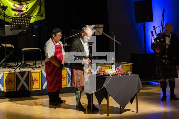 Picture by Sophie Rabey.  31-01-26.  Guernsey's Scottish Association held the Burns Night celebrations at Beau Sejour, sponsored by Titan Wealth.  The Haggis was piped in by Chris Bradshaw (piper) and carried by Mikee Bataller (chef).
Stuart Hardie (Past President of the GSA) doing the Address to the Haggis, followed by the drinking of whiskey.