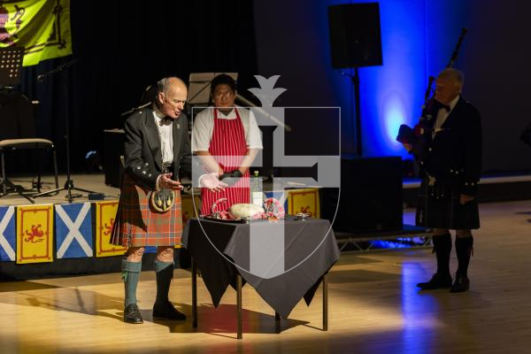 Picture by Sophie Rabey.  31-01-26.  Guernsey's Scottish Association held the Burns Night celebrations at Beau Sejour, sponsored by Titan Wealth.  The Haggis was piped in by Chris Bradshaw (piper) and carried by Mikee Bataller (chef).
Stuart Hardie (Past President of the GSA) doing the Address to the Haggis, followed by the drinking of whiskey.