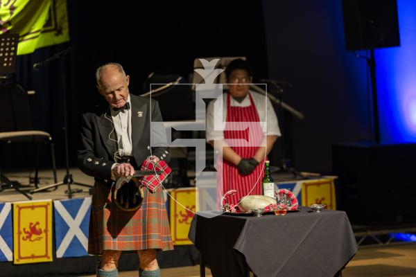 Picture by Sophie Rabey.  31-01-26.  Guernsey's Scottish Association held the Burns Night celebrations at Beau Sejour, sponsored by Titan Wealth.  The Haggis was piped in by Chris Bradshaw (piper) and carried by Mikee Bataller (chef).
Stuart Hardie (Past President of the GSA) doing the Address to the Haggis, followed by the drinking of whiskey.