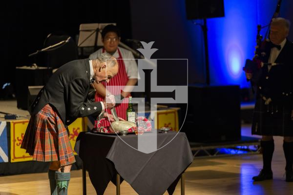 Picture by Sophie Rabey.  31-01-26.  Guernsey's Scottish Association held the Burns Night celebrations at Beau Sejour, sponsored by Titan Wealth.  The Haggis was piped in by Chris Bradshaw (piper) and carried by Mikee Bataller (chef).
Stuart Hardie (Past President of the GSA) doing the Address to the Haggis, followed by the drinking of whiskey.