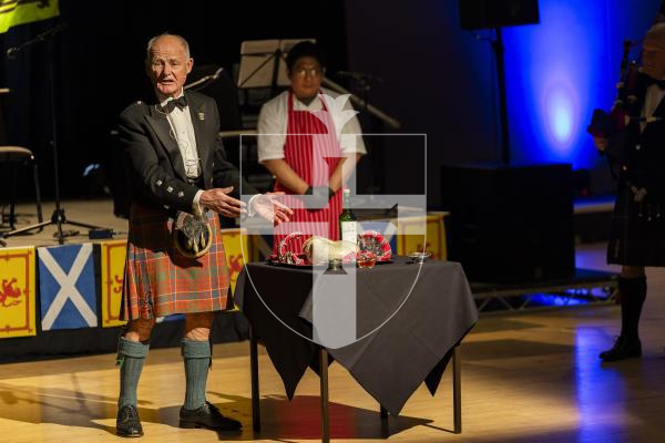 Picture by Sophie Rabey.  31-01-26.  Guernsey's Scottish Association held the Burns Night celebrations at Beau Sejour, sponsored by Titan Wealth.  The Haggis was piped in by Chris Bradshaw (piper) and carried by Mikee Bataller (chef).
Stuart Hardie (Past President of the GSA) doing the Address to the Haggis, followed by the drinking of whiskey.