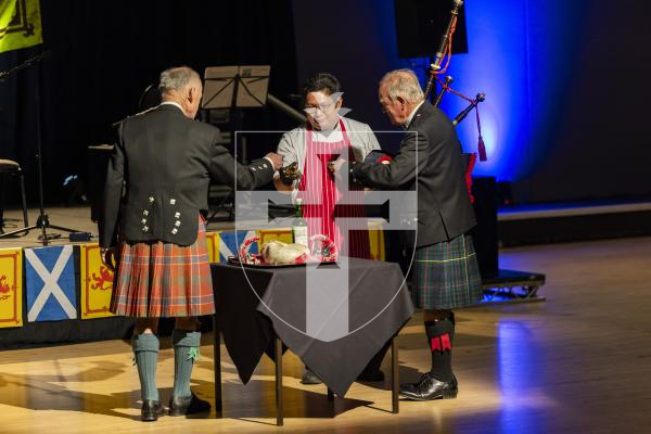 Picture by Sophie Rabey.  31-01-26.  Guernsey's Scottish Association held the Burns Night celebrations at Beau Sejour, sponsored by Titan Wealth.  The Haggis was piped in by Chris Bradshaw (piper) and carried by Mikee Bataller (chef).
Stuart Hardie (Past President of the GSA) doing the Address to the Haggis, followed by the drinking of whiskey.