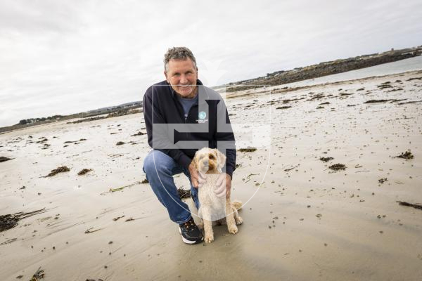 Picture by Sophie Rabey.  18-09-25.  Steve Snell and his dog, Biscuit, on Chouet Beach for story on dogs being allowed on more beaches across the island.