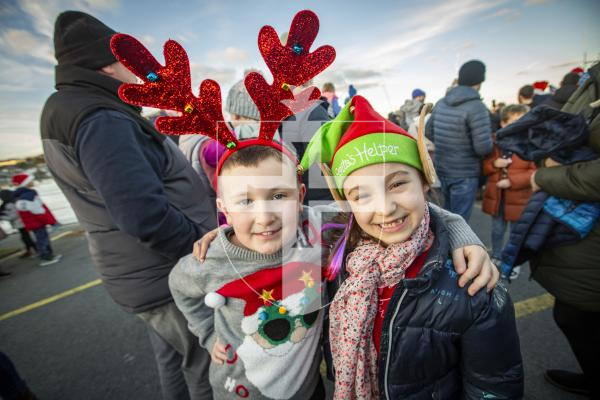 Picture by Sophie Rabey.  25-11-23.  Father Christmas comes to St Peter Port town to switch on the Christmas lights 2023.
L-R Jake Webb (7) and Lily-Grace Odillard (6)