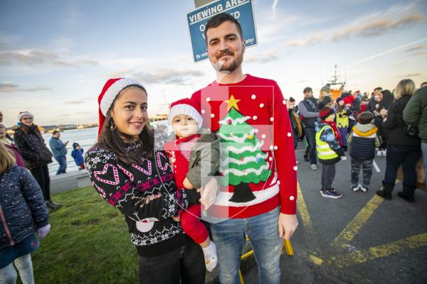 Picture by Sophie Rabey.  25-11-23.  Father Christmas comes to St Peter Port town to switch on the Christmas lights 2023.
Jasmine Blanchford-Gibney, baby Casey Ferbrache (agrd 1) and Jay Ferbrache.